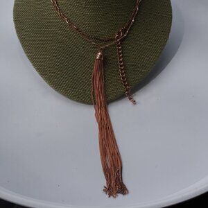Women`s copper colored long tassel necklace.